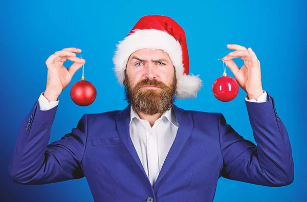 Christmas atmosphere spread around. Holidays meant for fun. Man bearded wear formal suit and santa hat. Businessman join christmas celebration. Santa hold christmas ball decoration. Merry christmas