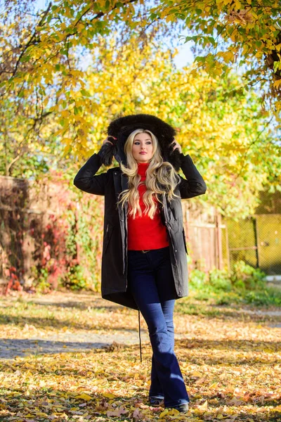 Woman wear black parka fur hood. Youth hipster fashion concept. Classic parka coat has become wardrobe icon. Versatile functional and stylish. Girl wear parka while walk park. Puffer jacket with hood