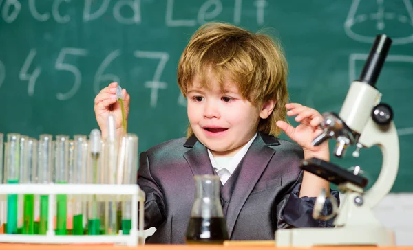 Ένα παιδί που μαθαίνει χημεία στο εργαστήριο. σχολείο επιστήμονας που σπουδάζει επιστήμη. Εργαστηριακός εξοπλισμός εργαστηρίου βιολογίας. Το μικρό αγόρι στο δημοτικό σχολείο. αγοράκι στο μάθημα. Πίσω στο σχολείο — Φωτογραφία Αρχείου
