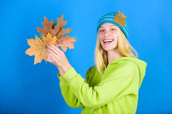 Active leisure and rest autumn season. Woman wear knitted hat hold fallen leaves. Skincare routine for autumn. Enjoy autumn season. Autumn skincare tips. Bright moment. Skincare and beauty tips
