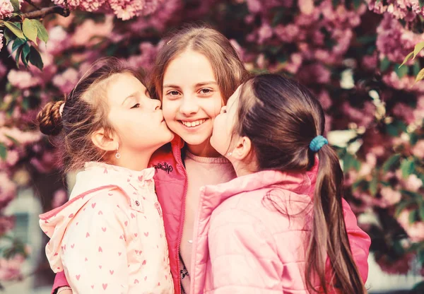 Sakura garden. Sisters friends sakura trees background. Kids pink flowers of sakura tree. Flowers tender bloom. Kids enjoy cherry blossom. True friendship. Pink our favorite. Children spring garden