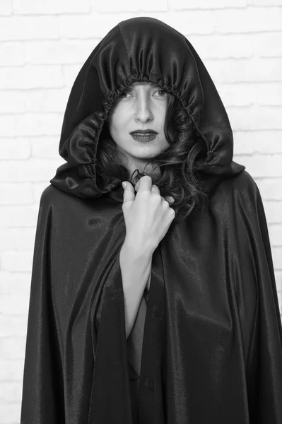 Halloween party. Damn pretty woman devil. Death in black cloak symbol. Vampire in cloak sexy devil girl. Woman tempting vampire demon. Girl covered with cloak. Devil concept. Halloween masquerade