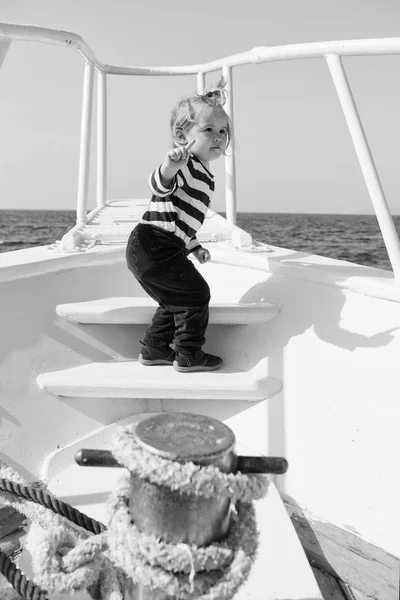 Boy sailor striped shirt sea yacht travel around world. Little sea traveller. Beach is calling and we must go. Baby boy enjoy vacation sea cruise ship. Child sailor. Boy sailor travelling sea