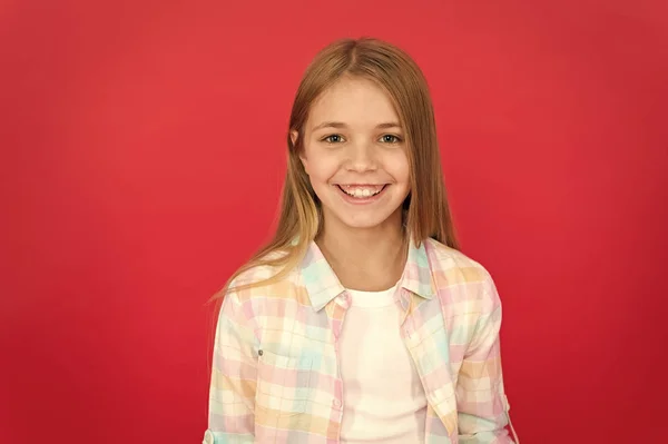 Girl joyful smiling face over red background. Emotional kid happy smiling face. Cheerful adorable girl smiling. Positive and optimistic. Cheerful mood. Sincere emotions. Brilliant smile concept — Stock Photo, Image