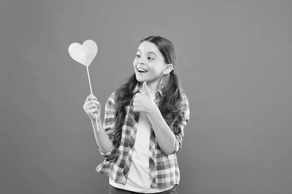 I definitely like this. Vote for love. Girl little child hold heart symbol on stick. Like and support. Valentines day. Fall in love. Love will save the world. Kid promoting love. Personal attitude