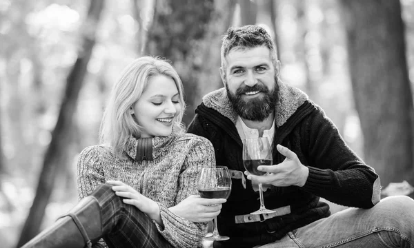 Happy loving couple relaxing in park together. Romantic picnic with wine in forest. Couple in love celebrate anniversary picnic date. Enjoying their perfect date. Couple cuddling drinking wine — Stock Photo, Image