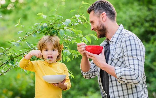healthy food and dieting. This should be fine. happy fathers day. Little boy with dad eat cereal. Family bonds. Enjoying time together. son and father eating outdoor. weekend morning breakfast