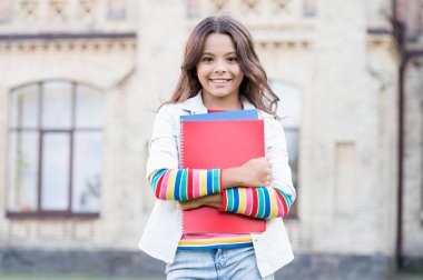 Modern education. Kid smiling girl school student hold workbooks textbooks for studying. Education for gifted children. Taking extra course for deeper learning. School education. Choice course clipart