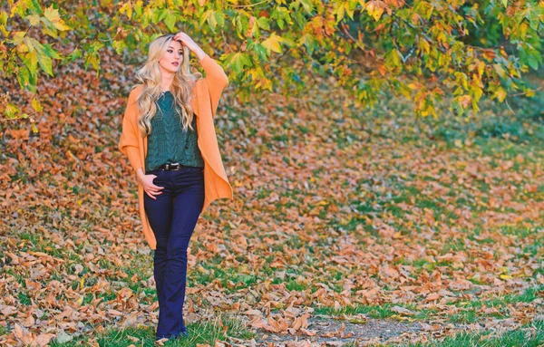 Woman walk sunset light. Cozy casual outfits for late fall. Comfortable outfit. Girl adorable blonde posing in warm and cozy outfit autumn nature background defocused. Cozy outfit ideas for weekend