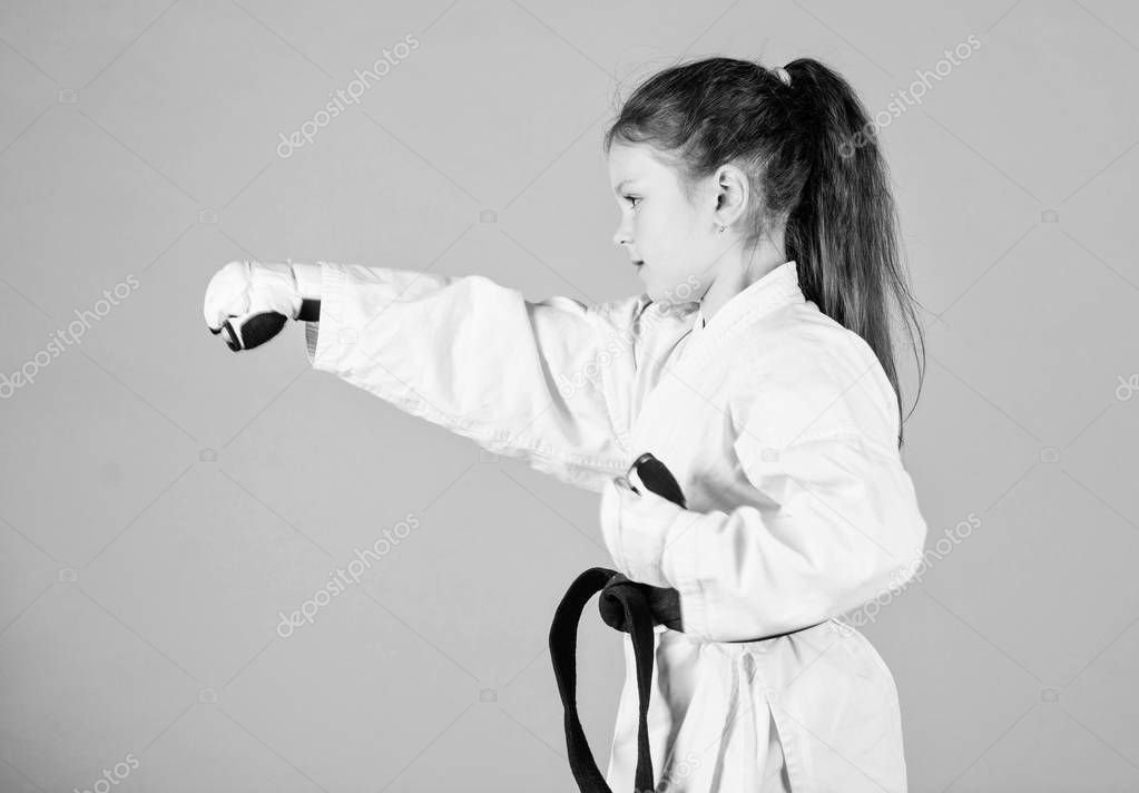 sport success in single combat. practicing Kung Fu. happy childhood. little girl in gi sportswear. small girl in martial arts uniform. knockout. energy and activity for kids. Free your mind