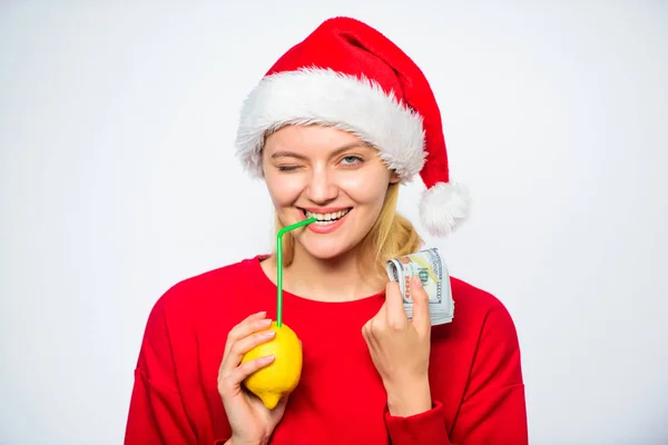 Christmas wishes. Rich girl with lemon and money. Woman lemon millionaire. Lemon money concept. Symbol of wealth and prosperity. Girl santa hat drink juice lemon straw while hold pile of money — Stock Photo, Image