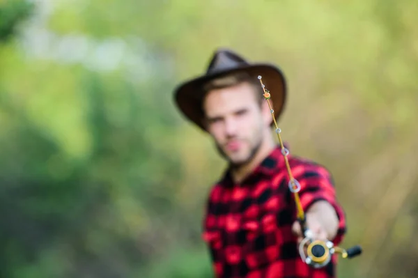 Hook and bait. Fishing hobby. Guy in cowboy hat fishing equipment nature background defocused. Hipster fisherman hold rod spinning selective focus. Hope for nice fishing. Fishing day. Proper fishhook — Stock Photo, Image