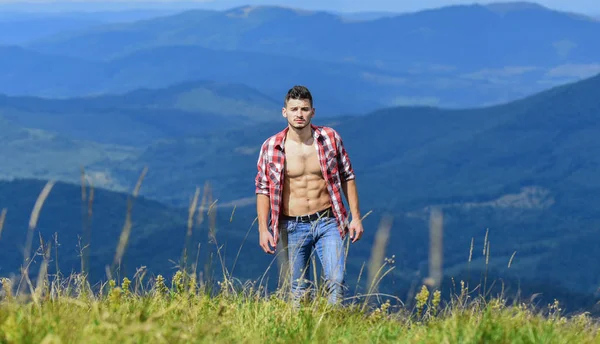 free spirit. man on mountain landscape. camping and hiking. cowboy in hat outdoor. countryside concept. farmer on rancho. travelling adventure. hipster fashion. sexy macho man in checkered shirt