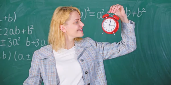 Always on time. Woman teacher hold alarm clock. She cares about discipline. Time to study. Welcome teacher school year. Looking committed teacher complement qualified workforce educators
