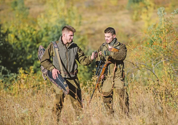 Illegal hunting. Hunters friends enjoy leisure. Poacher partner in crime. Activity for real men concept. Hunters gamekeepers looking for animal or bird. Hunters with rifles in nature environment — Stock Photo, Image