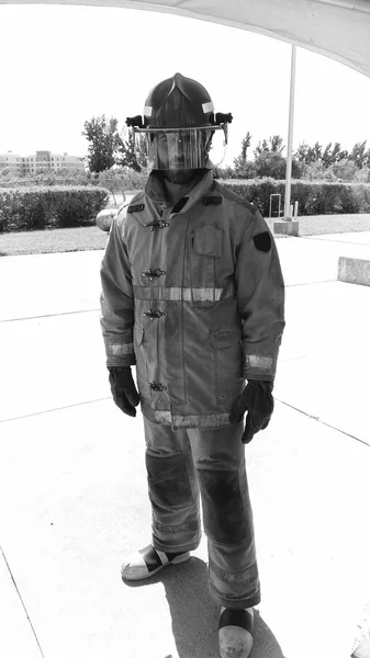 My job is extinguish fires. On guard. Firefighter with uniform and helmet. Masculinity and male job. Manly duty. Fireman firefighter serious man. Fire safety measures. Professional firefighter