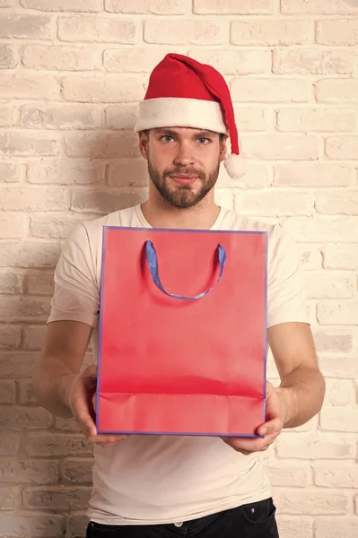 happy santa man. delivery christmas gift. man in santa hat hold christmas present. online christmas shopping. Happy new year, copy space. The morning before Xmas. Christmas fun. Winter holidays sales