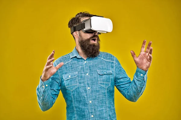 Virtual reality is truly here. Bearded man wear virtual reality headset. Hipster explore virtual reality yellow background. Virtual reality technology and future. VR communication. Video training