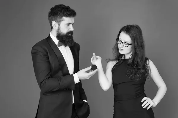 tuxedo man and elegant lady at wedding party. formal couple. ring in box. love date and romance. bearded man make woman marriage proposal. valentines day. sexy couple in love. wedding party