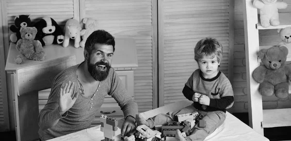 Man en jongen spelen met speelgoed blokken op houten achtergrond — Stockfoto