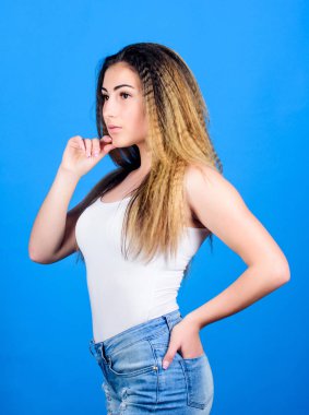 Yıpranmış saçlar. Ekstra hacim. Stil kozmetik ürün. Kıvrımlı saç modelleri. Mavi arka plan üzerinde kadın şık saç modeli. Saç kıvrımlama yöntemi şekillendirme saç dalgalı olur. Manken. Kuaför salonu