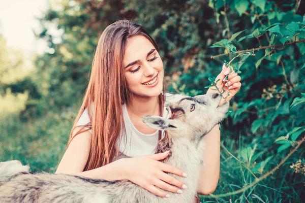 Hello pets. woman vet feeding goat. farm and farming concept. Animals are our friends. happy girl love goat. village weekend. summer day. Love and protect animals. contact zoo. veterinarian lamb goat