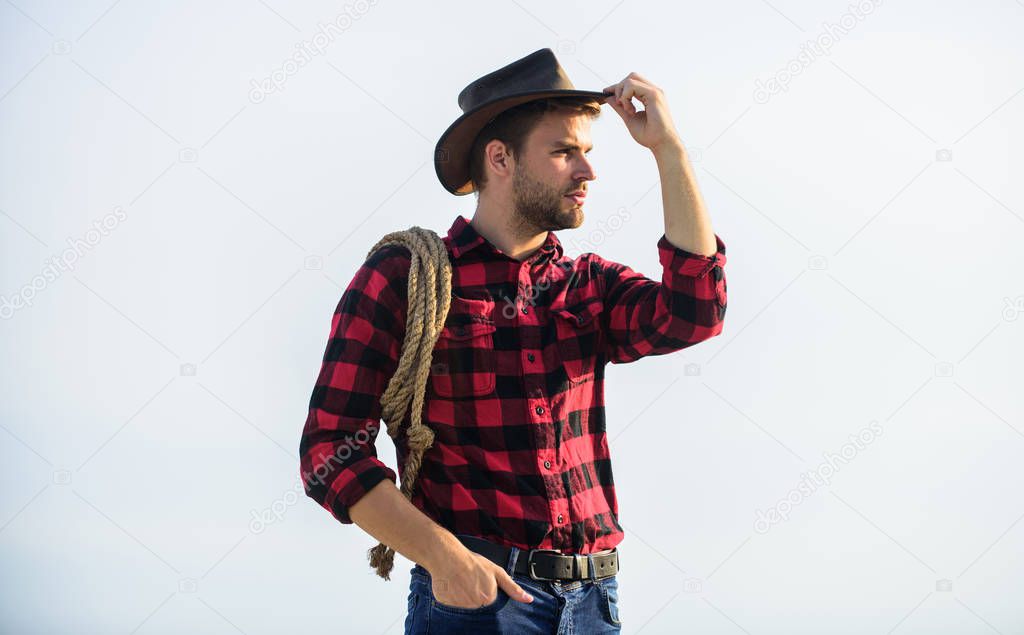 here is my heart. man checkered shirt on ranch. western cowboy portrait. cowboy with lasso rope. Western. wild west rodeo. Thoughtful man in hat relax. Vintage style man. Wild West retro cowboy