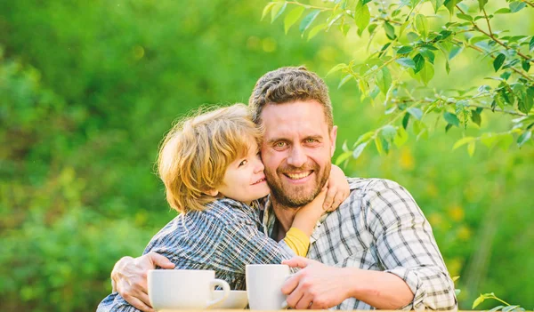 Healthy food. Father and boy drink tea outdoors. Develop healthy eating habits. Feed baby. Natural nutrition concept. Fathers day. Best friends. Father and son having fun. Feeding son natural foods — Stock Photo, Image