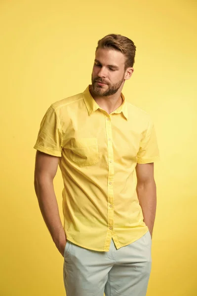 Casual style. Man on calm face posing confidently put hands pockets. Man attractive in casual shirt. Guy fashion model wear casual shirt. Feel comfortable in simple outfit. Casual comfortable outfit