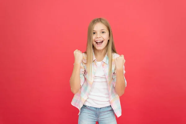 Sempre bem sucedido. infância feliz. Criança loira sorridente. menina com cabelo loiro longo. estilo casual. Dia das crianças. menina na moda. moda infantil. beleza elegante. menina pequena fundo vermelho — Fotografia de Stock