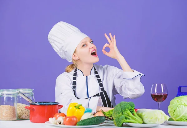 Meisje schattig chef-kok leren culinair. Beste culinaire recepten om thuis te proberen. Geweldige smaak. Verander ingrediënten in een heerlijke maaltijd. Culinaire vaardigheden. Vrouw chef-kok dragen hoed schort in de buurt van tabel ingrediënten — Stockfoto