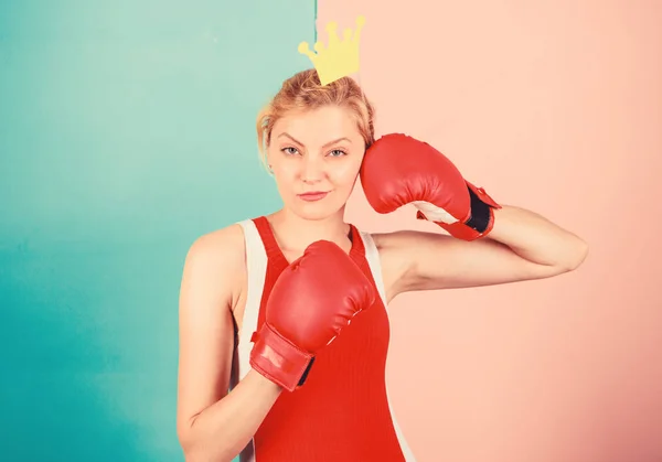 Queen of sport. Become best in boxing sport. Feminine tender blonde with queen crown wear boxing gloves. Fight for success. VIP gym. Fighting queen. Woman boxing glove and crown symbol of princess
