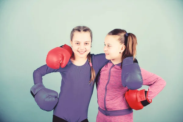 Competitors on ring and friends in life. Boxer children in boxing gloves. Confident teens. Female boxers. Boxing provide strict discipline. Girls cute boxers on blue background. Girls in boxing sport — Stock Photo, Image