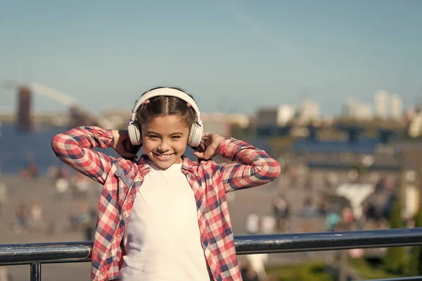 Enjoy music everywhere. Best music apps that deserve a listen. Girl child listen music outdoors with modern headphones. Listen for free. Get music family subscription. Access to millions of songs