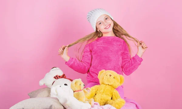 Child small girl playful hold teddy bear plush toy. Teddy bears improve psychological wellbeing. Unique attachments to stuffed animals. Kid little girl play with soft toy teddy bear pink background