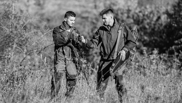 Hunters friends enjoy leisure. Poacher partner in crime. Activity for real men concept. Hunters gamekeepers looking for animal or bird. Hunters with rifles in nature environment. Illegal hunting — Stock Photo, Image