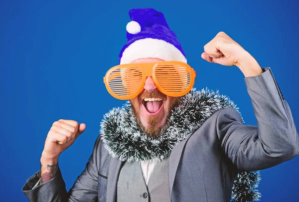 Corporate party ideas employees will love. Corporate christmas party. Man bearded hipster wear santa hat and funny sunglasses. Christmas party organisers. Guy tinsel ready celebrate new year