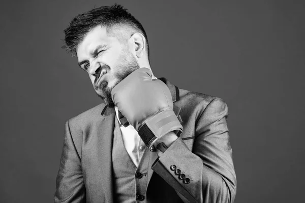 Work hard play hard. Business and sport success. knockout and energy. Fight. businessman in formal suit and tie. powerful man boxer ready for corporate battle. bearded man in boxing gloves punching