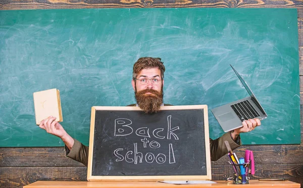 Teacher welcomes new pupils enter educational institution. Teacher or school principal welcomes with blackboard inscription back to school. Come to us. Private school advertising to boost enrollments