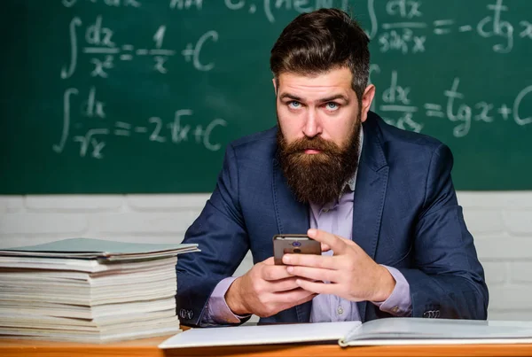 Meet the man leading the online education. Man teacher use new technology at school. Business man buy online. Digital marketing. Man bearded hold mobile phone