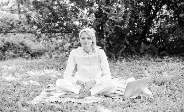 Woman with laptop or notebook sit on rug green grass meadow. Business picnic concept. Steps to start freelancing business. Online business ideas concept. Business lady freelancer work outdoors