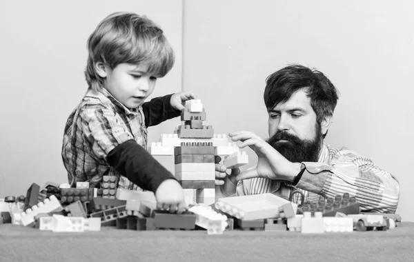 Enjoying time together. building home with colorful constructor. happy family leisure. small boy with dad playing together. child development. father and son play game. Done with you