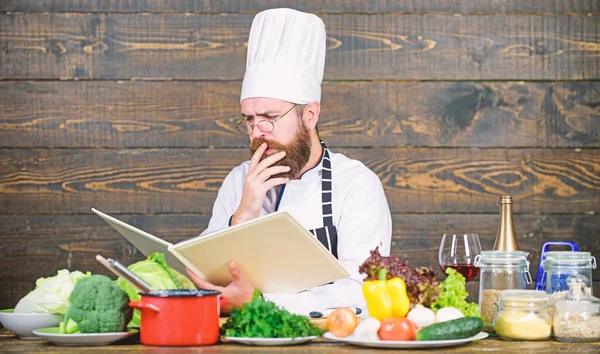 Book recipes. According to recipe. Man bearded chef cooking food. Guy read book recipes. Culinary arts concept. Man learn recipe. Try something new. Cookery on my mind. Improve cooking skill — Stock Photo, Image