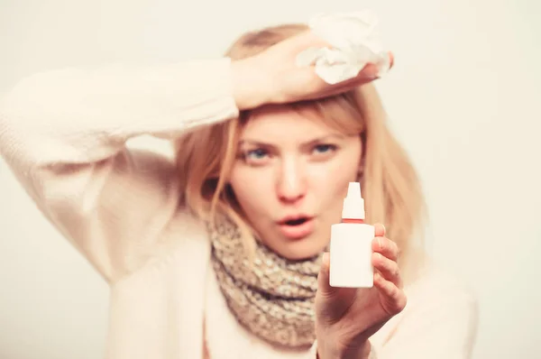 Do not spray into your mouth. Sick woman spraying medication into nose. Cute woman nursing nasal cold or allergy. Unhealthy girl with runny nose using nasal spray. Treating cold or allergic rhinitis — Stock Photo, Image