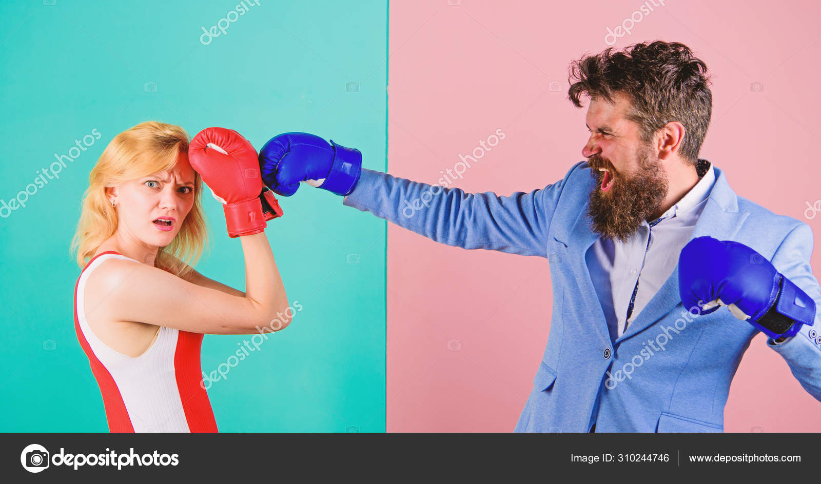 Couple in love competing in boxing. Female and male boxers fighting in gloves. Domination concept. Gender battle. Gender equal rights image