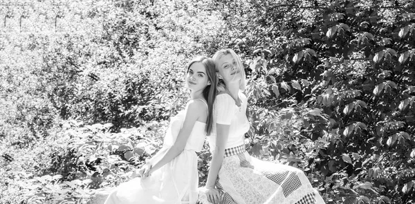 spring nature lovers. natural beauty. summer fashion. beautiful women in green park. sexy girls relax outdoor. Sisterhood vacation. freshness of healthy skin. skincare and wellness. Summer Vacation