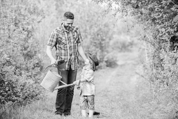 Happy earth day. Family tree nursering. Eco farm. small boy child help father in farming. use watering can and pot. Garden equipment. father and son in cowboy hat on ranch. Tender moment — Stock Photo, Image