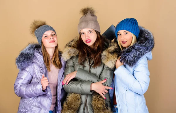 Female fashion. Girls friends having fun in winter. Emotional women in jackets. Group friends hang out together. Female clothes shop. Modern trendy female outfit. Gorgeous girls makeup faces cuddling