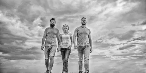 Friendship tested for years. United threesome true friends. Men and woman walks dramatic cloudy sky background. True friendship grow with destiny obstacles. United group purposefully moves forward — Stock Photo, Image