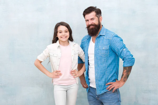 My father is hipster. Happy hipster and little girl on grey background. Bearded hipster and small child smiling in casual style. Caucasian hipster and his adorable daughter